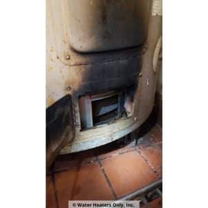 an old burner assembly on an old water heater