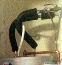 Insulation on the hot and cold lines of a newly installed water heater.